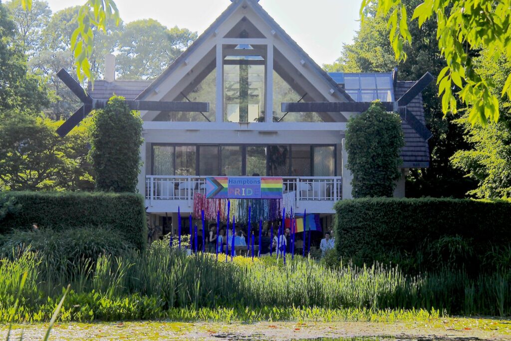 photo of LongHouse's facade, with a banner displaying the Hamptons Pride logo.
